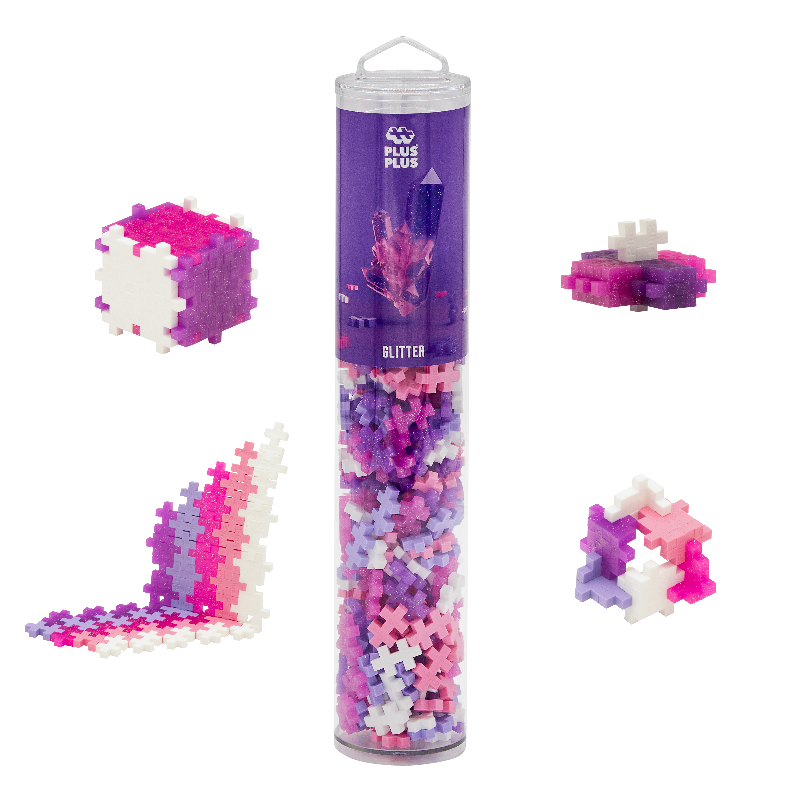 Plus Plus glitter building block set with a cylindrical tube and assembled structures on a white background