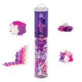 Plus Plus glitter building block set with a cylindrical tube and assembled structures on a white background