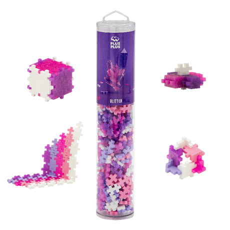Plus Plus glitter building block set with a cylindrical tube and assembled structures on a white background
