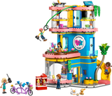 LEGO Friends toy set with a multi-story building, characters, and accessories on a white background