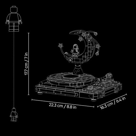 White line-art dimension diagram of a LEGO-style astronaut moon display set on a black background, showing the full height from a minifigure to the top of the display and the base dimensions.