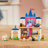Toy castle set with characters and animals on a wooden surface