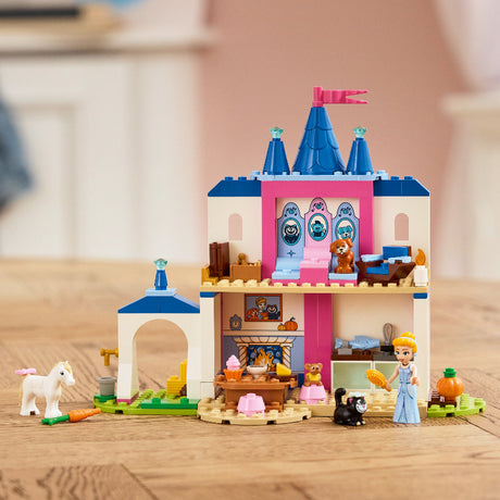 Toy castle set with characters and animals on a wooden surface