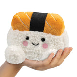 Plush toy shaped like a piece of sushi held in a hand on a white background