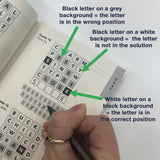 Hand holding a pen over a wordle puzzle with color-coded instructions on letter positions.