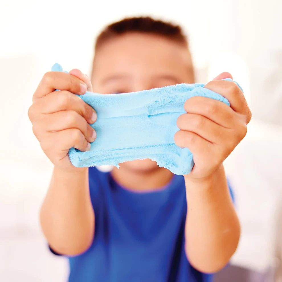 Child holding blue slime in front of their face against a white background