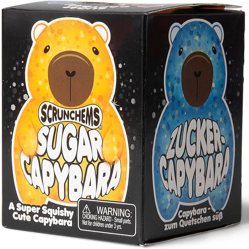 Scrunchems Sugar Capybara toy packaging box showing two bear designs on the front and side panels: a yellow-orange capybara on the left and a blue capybara on the right, with the Scrunchems brand name visible.