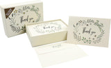 A boxed thank you card set with a floral wreath illustration and the words 'thank you' on the card, shown with an open box, a closed box, and an envelope on a white background.