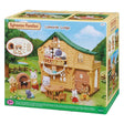 Sylvanian Families Lakeside Lodge toy set in its original retail packaging, showing a detailed illustration of the wooden lodge with animal characters and accessories.