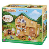 Sylvanian Families Lakeside Lodge toy set in its original retail packaging, showing a detailed illustration of the wooden lodge with animal characters and accessories.