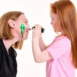 Person applying green zombie blood gel to another person's face on a white background