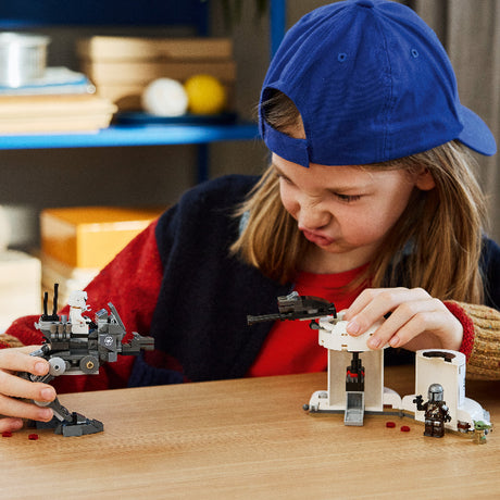 Child playing with LEGO sets on a wooden table