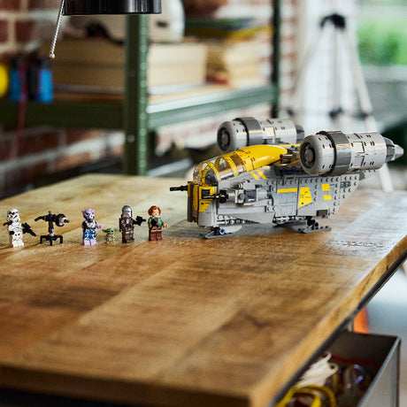 LEGO model of a spaceship and figures on a wooden table with a blurred background