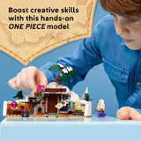 Child playing with a One Piece model set on a blue background