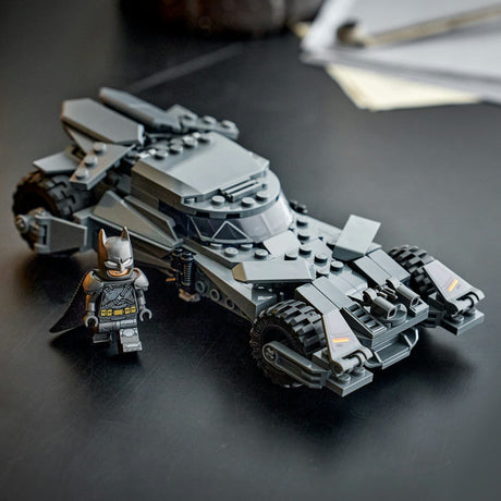 Toy Batmobile and Batman figure on a dark surface