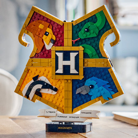 LEGO Hogwarts school crest with four animals on a wooden surface.