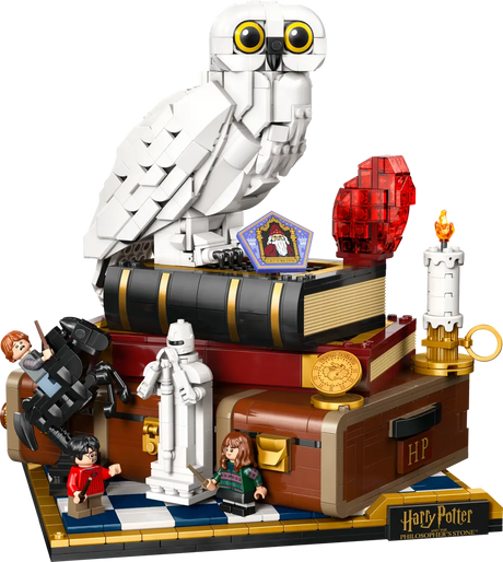 LEGO Harry Potter set with owl, books, and characters on a white background