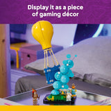 Toy set with a yellow hot air balloon and blue characters on a table, with text 'Display it as a piece of gaming décor'.