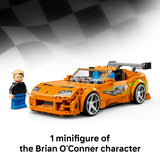LEGO model of a sports car with a minifigure next to it on a checkered background