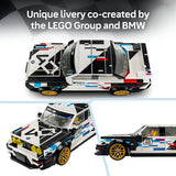 LEGO Group and BMW co-created livery race car building blocks set, shown from multiple angles: top-down, front-three-quarter, and side-profile views. The set features a white, black, blue, and red race car with gold wheels and a yellow driver figure, with text at the top reading 'Unique livery co-created by the LEGO Group and BMW'.