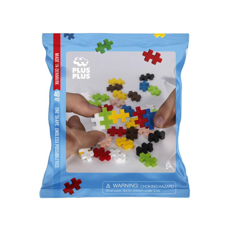 Package of Plus-Plus building set with colorful puzzle pieces on a white background