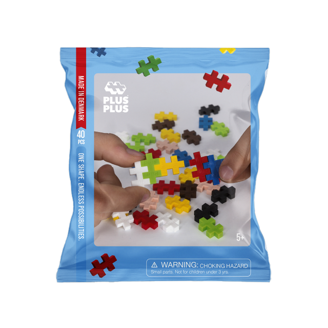 Package of Plus-Plus building set with colorful puzzle pieces on a white background