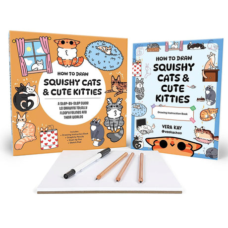 A drawing guide set for 'Squishy Cats & Cute Kitties' by Vera Kay, featuring an illustrated book with an orange cover, another book with a blue cover, a white notepad, and three drawing pencils on a white background.