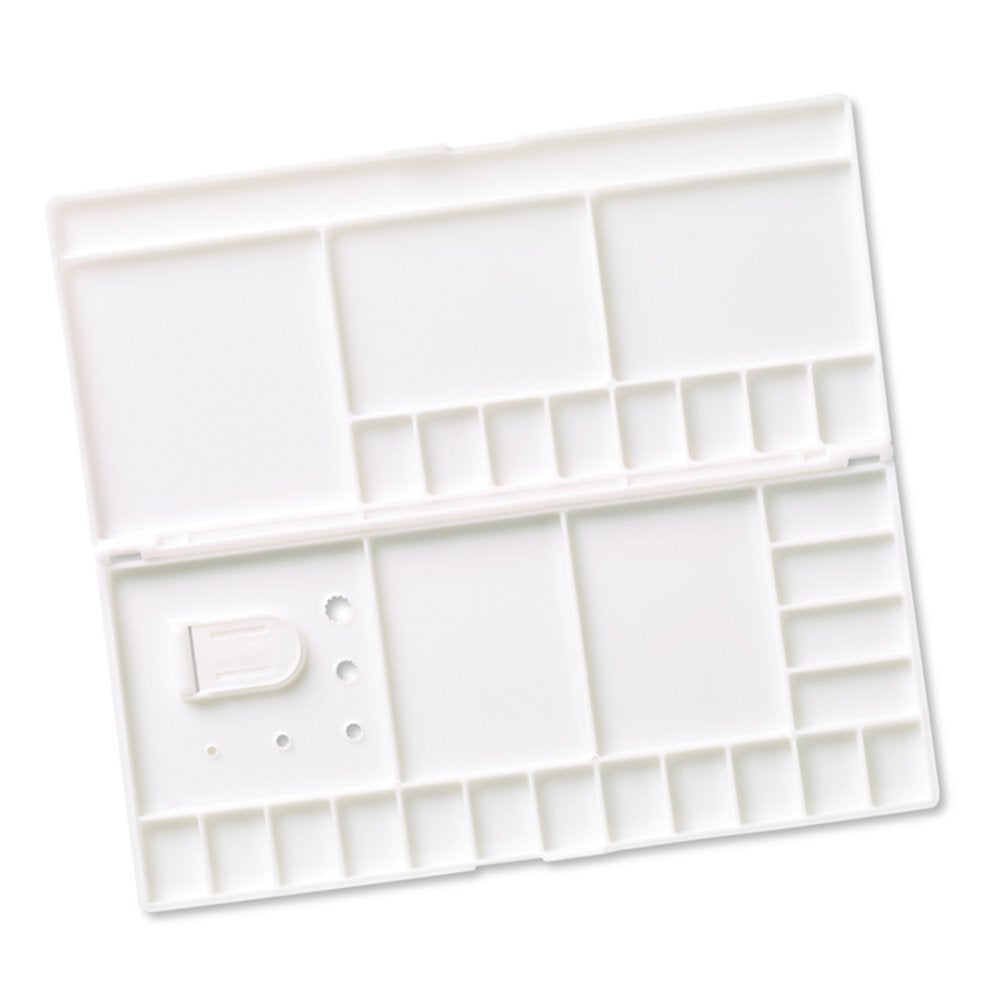 White paint palette with multiple compartments on a white background