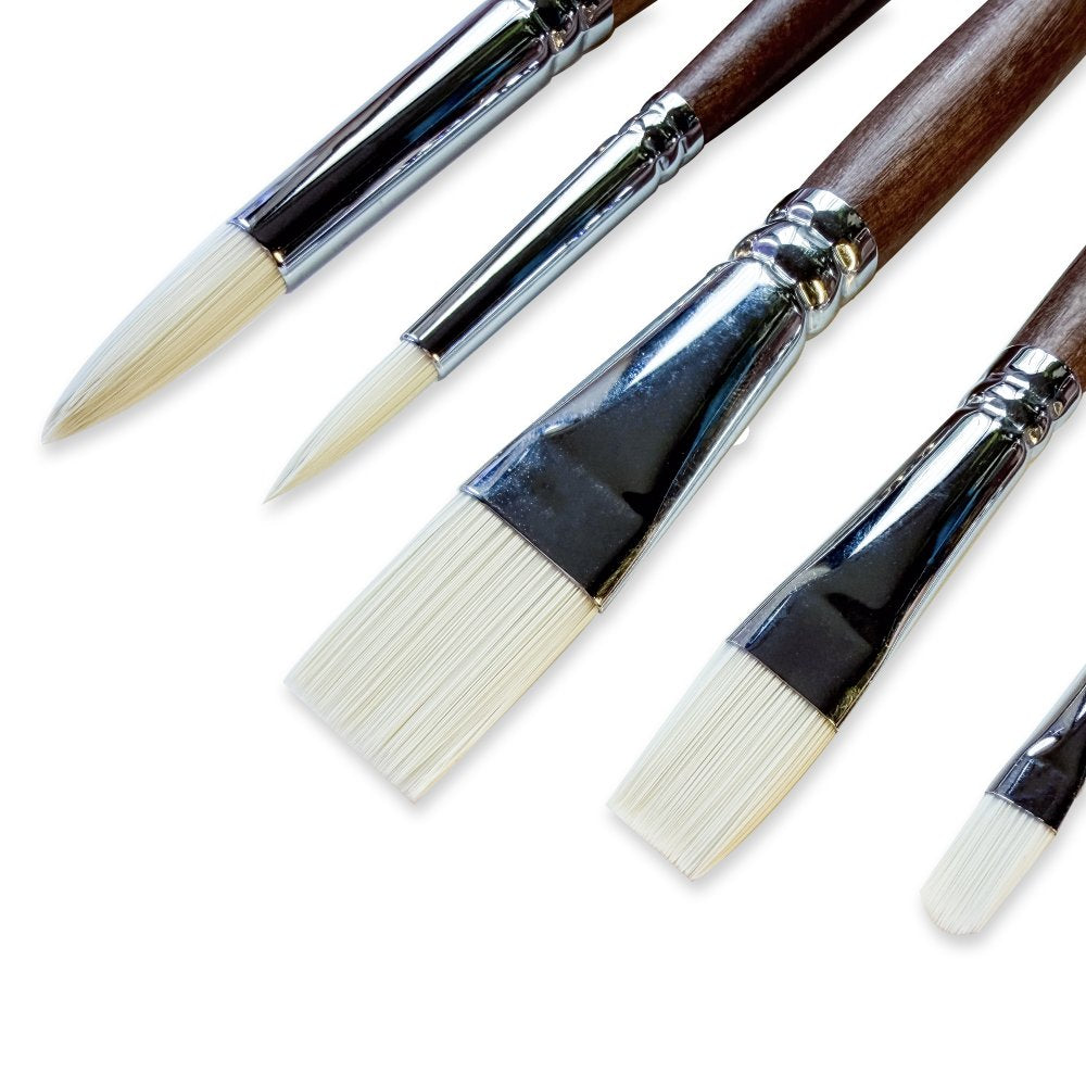 Set of paint brushes with wooden handles on a white background