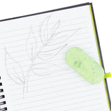 Green eraser on a notebook with leaf drawings