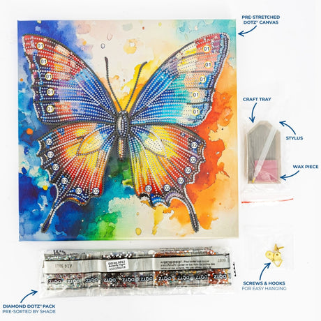 A diamond dot painting kit for canvas featuring a colorful butterfly design. The image shows the pre-stretched canvas with the completed butterfly artwork, a craft tray with wax pieces, a stylus, screws and hooks, and a pack of pre-colored diamond dot beads labeled 'Butterfly Multicolor'.