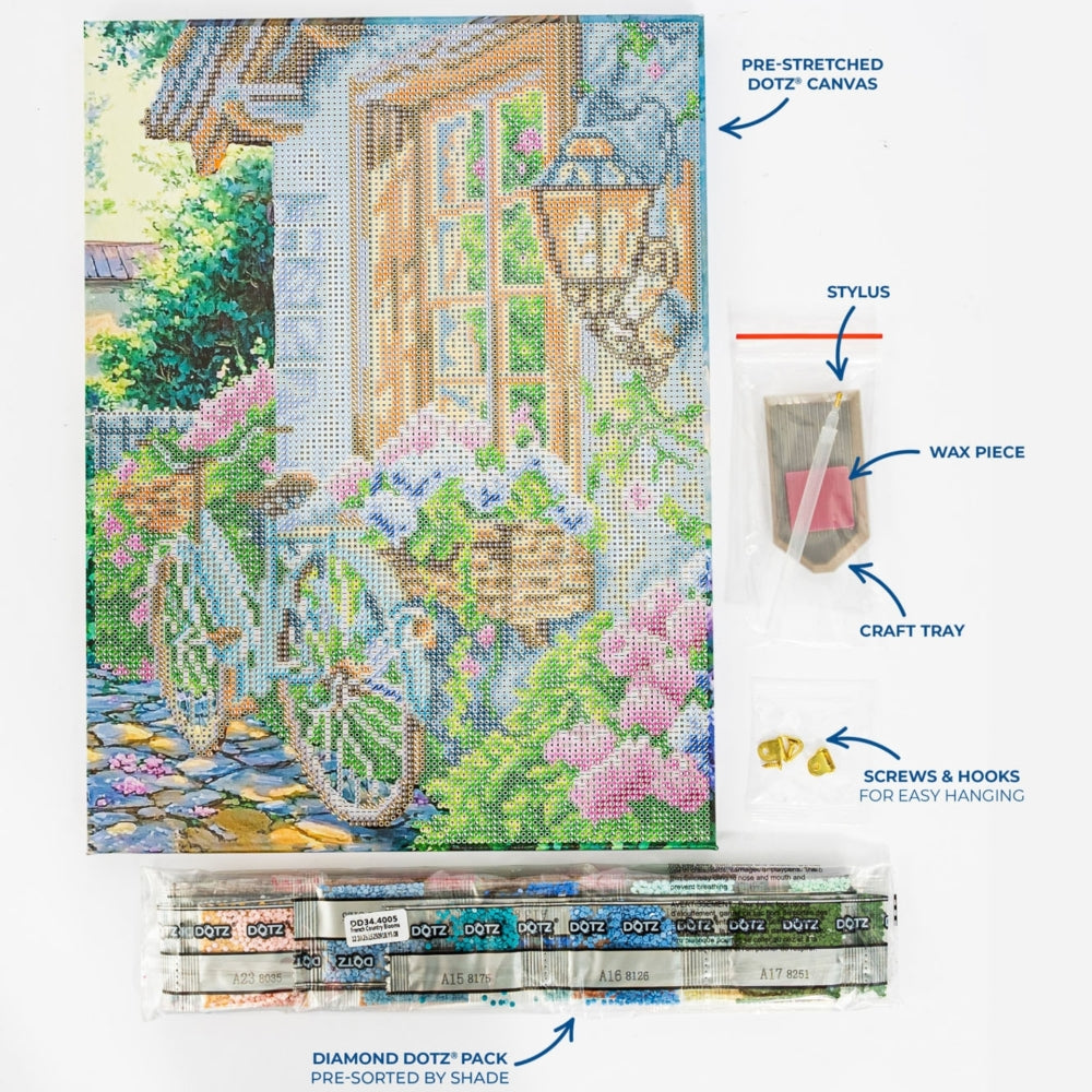 A diamond painting kit layout showing a completed multicolor garden and house scene on a pre-stretched canvas, with labeled accessories including a stylus, wax piece, craft tray, screws & hooks, and a pack of diamond dotz. The image is not a person-in-environment lifestyle shot and functions as a product explainer layout, so Product/Packaging is the best fit.
