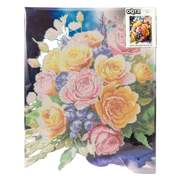 A completed diamond painting floral artwork showing a bouquet of yellow, pink, peach, and purple flowers with green leaves, photographed flat against a white background. A small DOTZ brand label is visible in the upper right corner of the artwork.