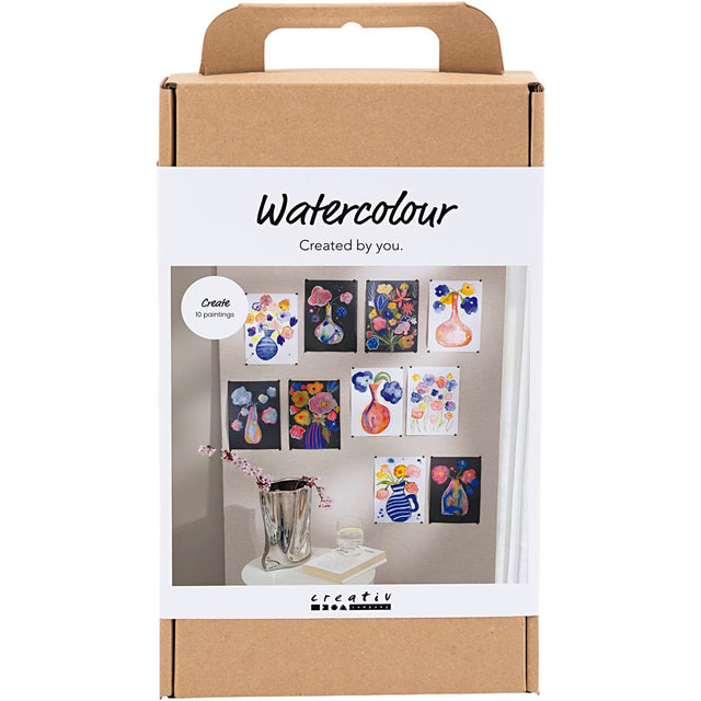 Packaging of watercolor art set with sample artworks on a white background