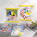 Colorful art prints on a gray surface with painting supplies.