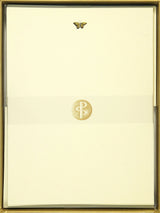 Gold-framed document with a logo on a beige background