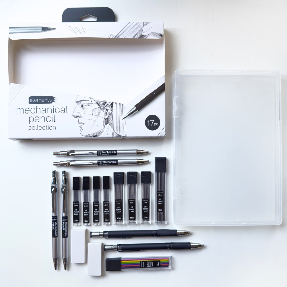 A 17-piece mechanical pencil collection set by Diagrams, neatly arranged on a white surface next to its clear plastic storage case. The set includes various silver and black mechanical pencils, ink cartridges, an eraser, and a color wheel, with the branded retail box visible in the upper left.