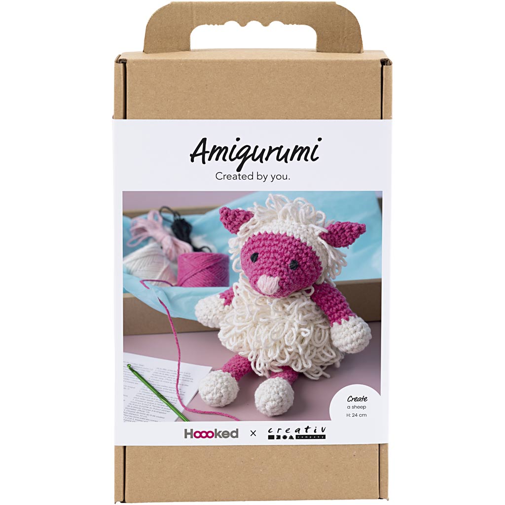 Amigurumi kit packaging with a small crocheted sheep and yarn on a white background
