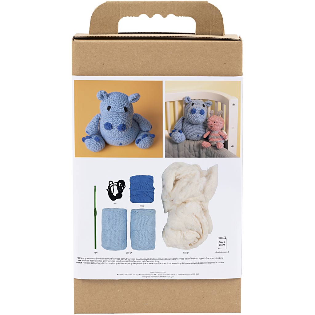 Crochet kit packaging with blue hippo toy, yarn, hook, and instructions on a white background