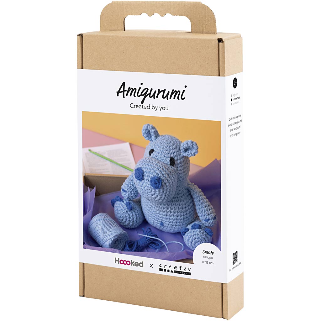Amigurumi hippo packaging with a blue hippo toy inside, on a white background.