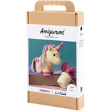 Amigurumi unicorn kit packaging with yarn and crochet hook on a white background