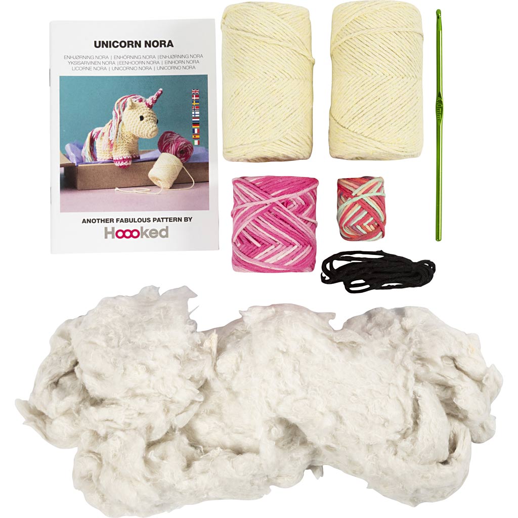 Knitting kit with yarn, needles, and pattern book on a white background