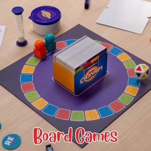 Cranium Board game with colorful pieces on a mat, featuring the brand 'Hasbro'.