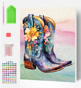 Colorful cowboy boots with floral design on a diamond painting canvas, surrounded by tools and materials.