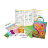 Cross-stitch kit with colorful threads, pattern chart, and butterfly design on a white background