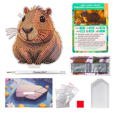 Capybara-themed craft kit with crystal art supplies on a white background