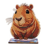 Hamster-shaped decorative item made from small beads on a white background