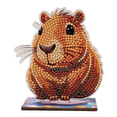 Hamster-shaped decorative item made from small beads on a white background