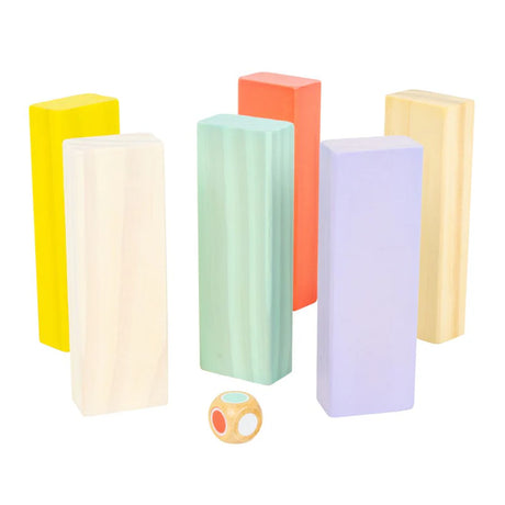 Set of colorful foam blocks with a small round die on a white background