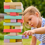 Child playing with colorful wooden blocks outdoors